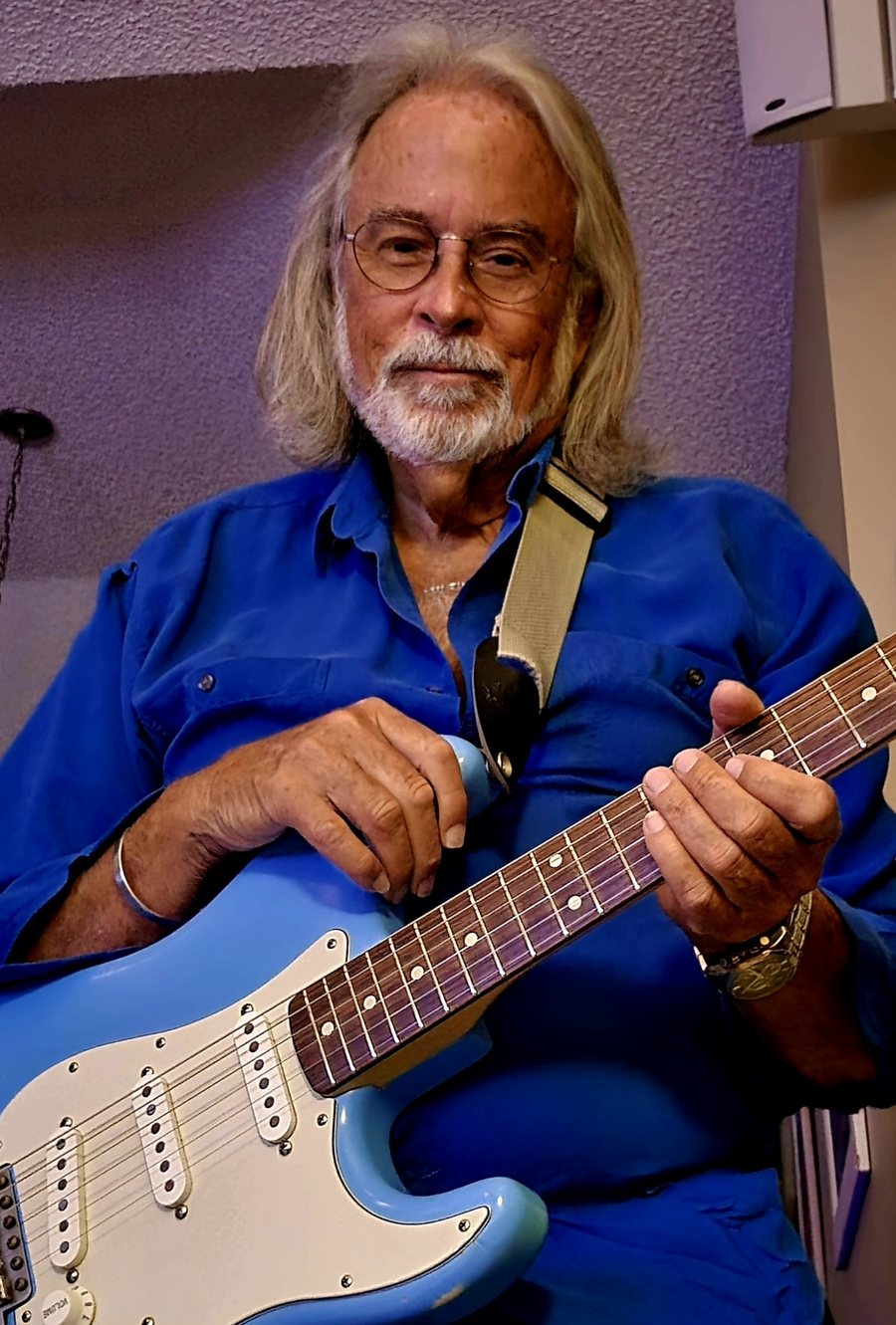 Chris, master luthier at Tempcom Guitar Shop, holding a guitar