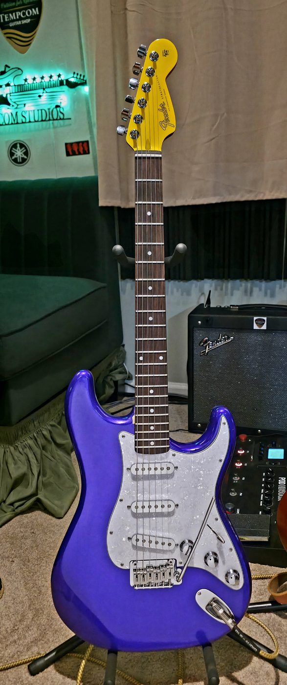Purple sparkle Stratocaster custom refinish, completed, on display in the shop